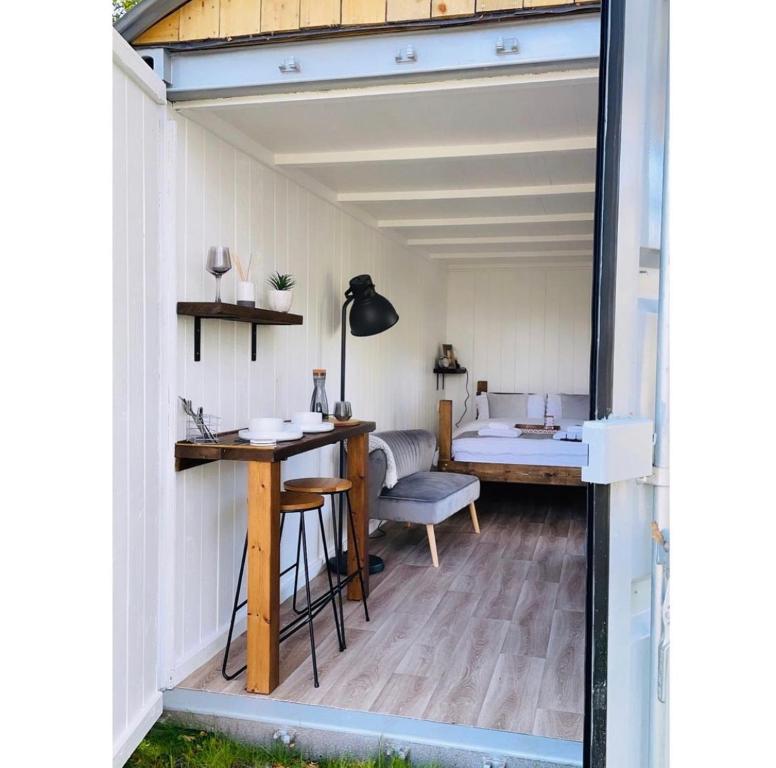 a tiny house with a desk and a room at Trethowels Hidden Huts in St Austell