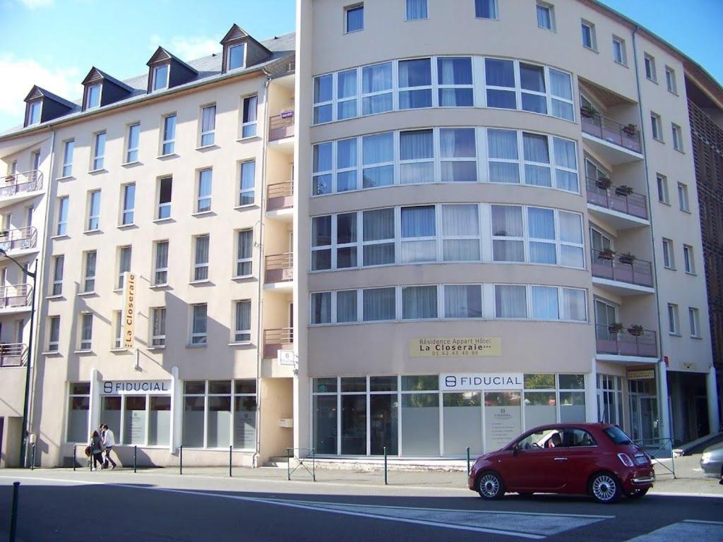 a red car parked in front of a building at Studio moderne et équipé Lourdes Centre in Lourdes