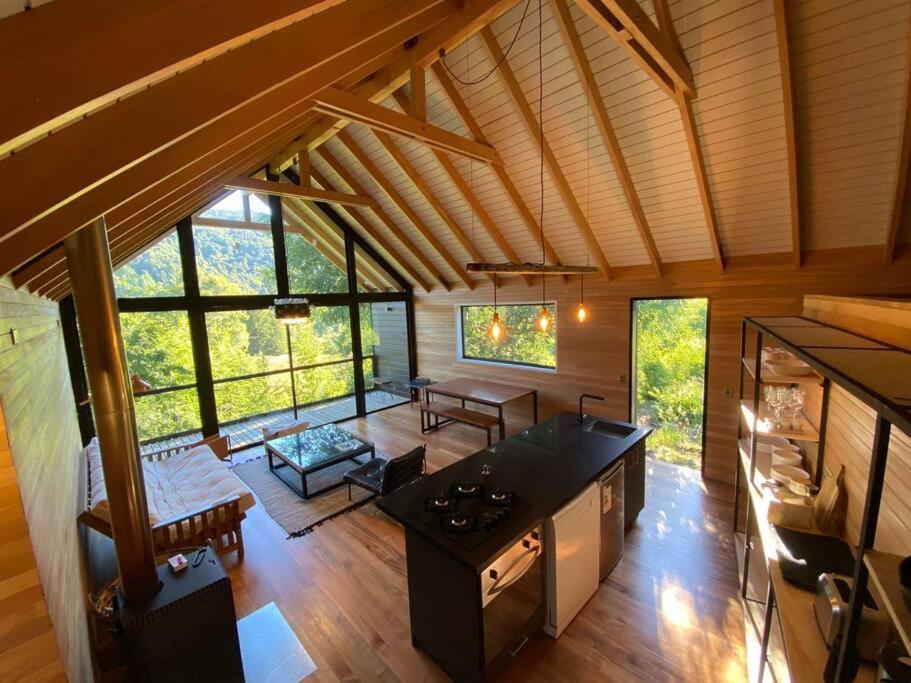 an overhead view of a kitchen and living room in a cabin at Luxury mountain loft in Pucón