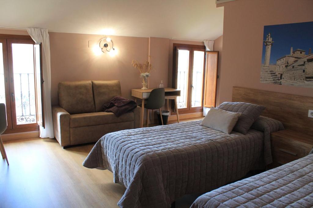 A bed or beds in a room at Apartamentos Turísticos ESCORRALADAS