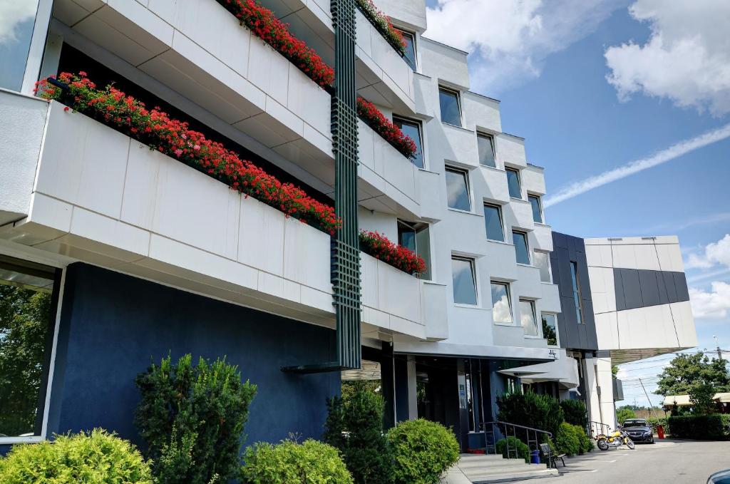 a building with flowers on the side of it at Best Lido Hotel in Timişoara