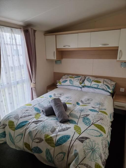 a bed with two pillows on it in a bedroom at Meadow Lakes 37 in Chapel Saint Leonards