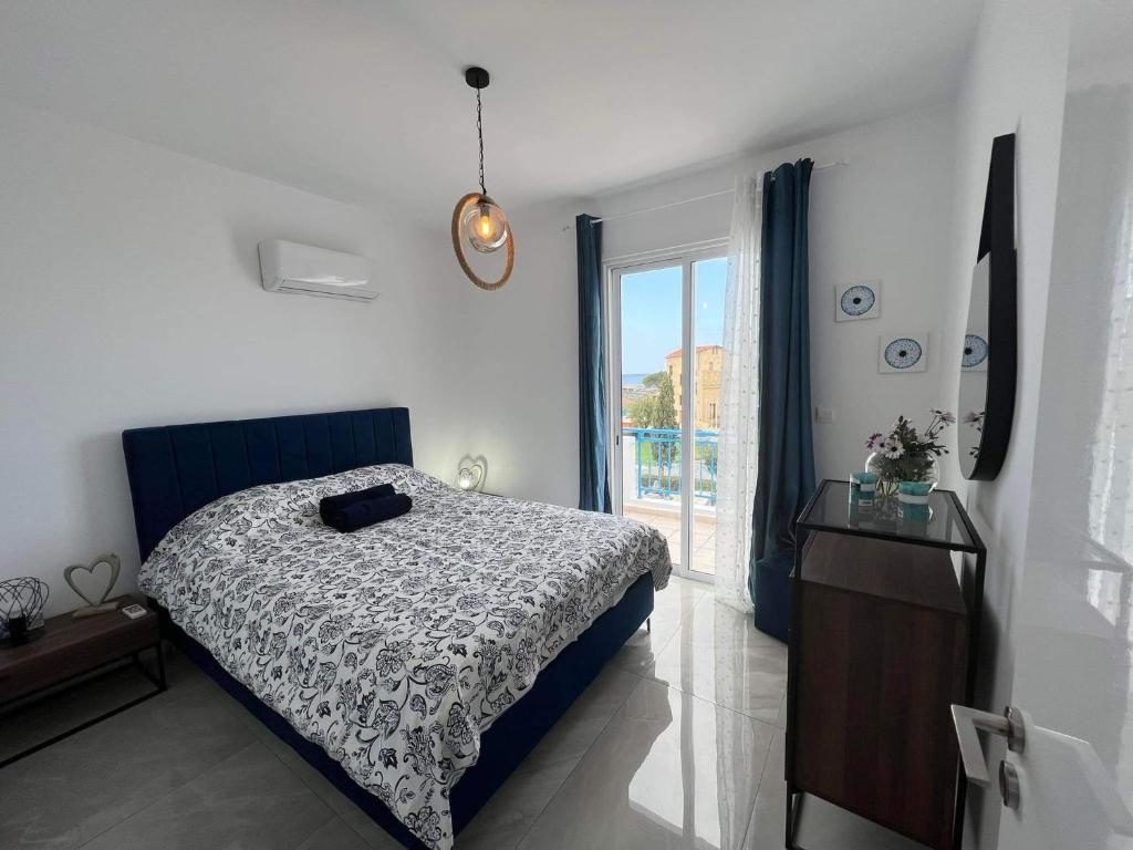 a bedroom with a bed and a large window at LATSI APARTMENT 16 fully renovated in Lachi