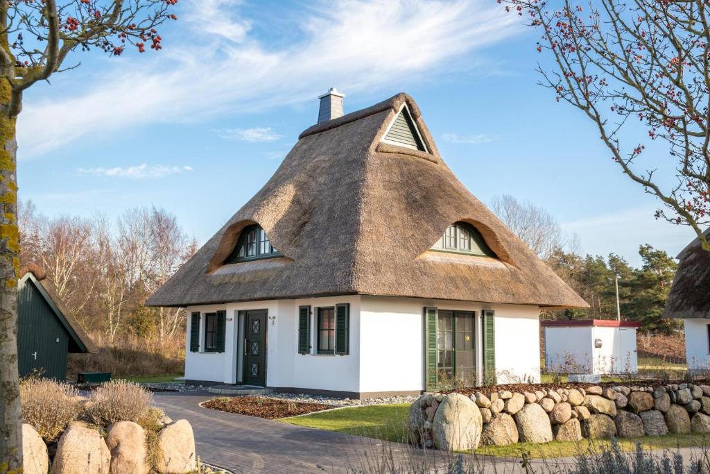a thatch roofed house with a thatched roof at Ferienhaus Seeadler 3 in Fuhlendorf