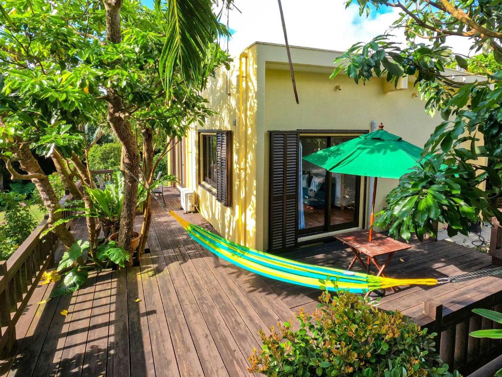 a hammock and an umbrella on a deck at Kachibai in Ishigaki Island