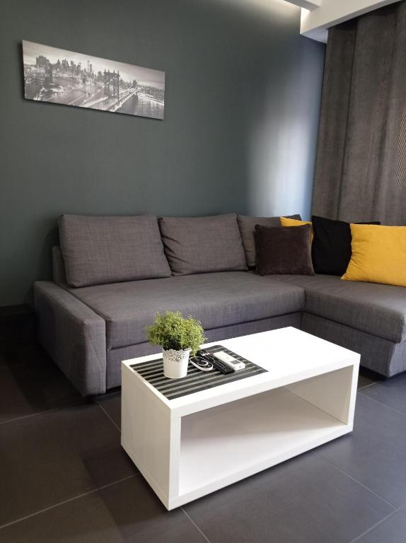 a living room with a couch and a white coffee table at NY Central 1 in Patra