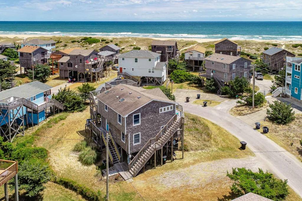 an aerial view of a beach house with a staircase at Dancing Dolphin 106 in Avon