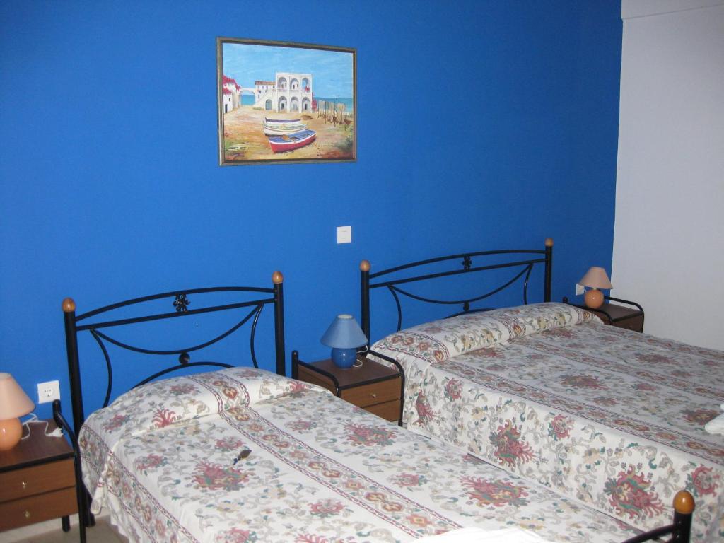 A bed or beds in a room at Calypso Hotel