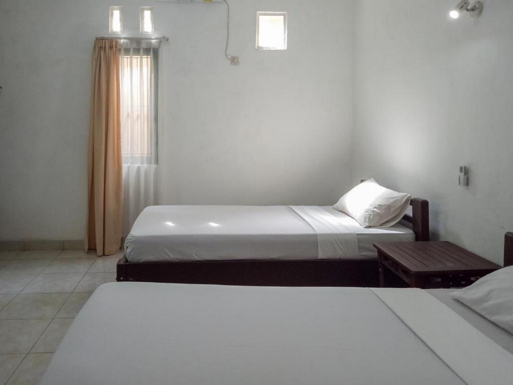 Postel nebo postele na pokoji v ubytování DATON HOUSE near Bali Zoo Ubud Mitra RedDoorz