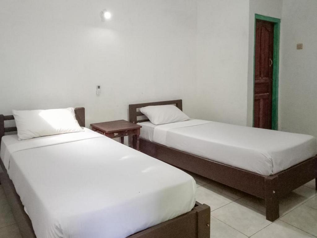 Postel nebo postele na pokoji v ubytování DATON HOUSE near Bali Zoo Ubud Mitra RedDoorz