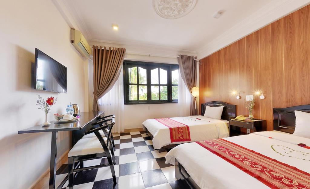 Postel nebo postele na pokoji v ubytování Hai Yen Hotel