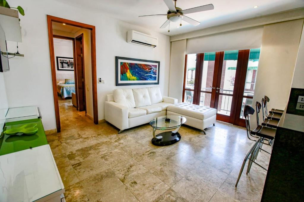 a living room with a white couch and a table at Luxury One Bedroom Apartment in the Old City in Cartagena de Indias