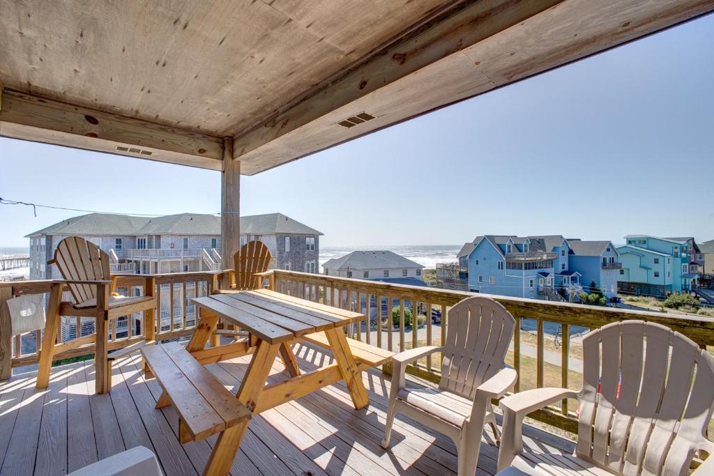 a deck with a table and chairs and the ocean at Waves Crest 338 IC in Avon
