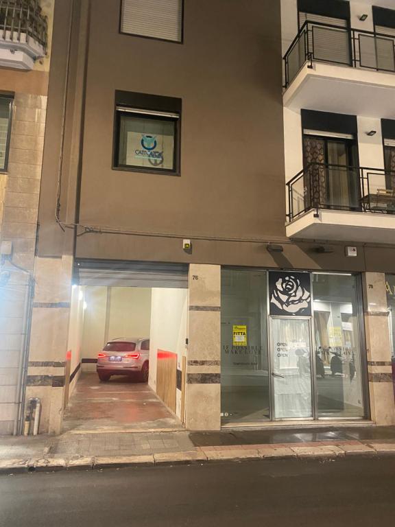 a car parked in a parking lot in front of a building at Urban Chic Home in Bari