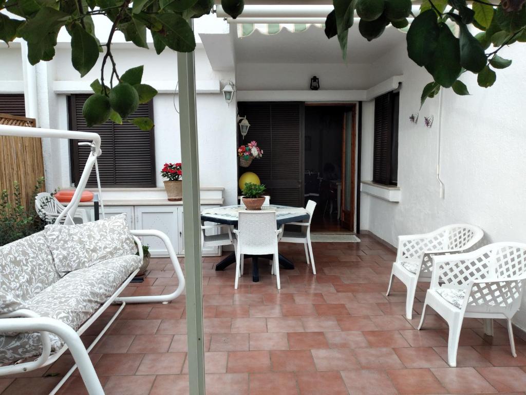 a patio with a couch and chairs and a table at Villetta Paola marina di Ostuni in Villanova di Ostuni