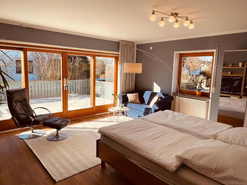 a bedroom with a bed and a living room at meinGästehaus im Fränkischen Seenland in Haundorf