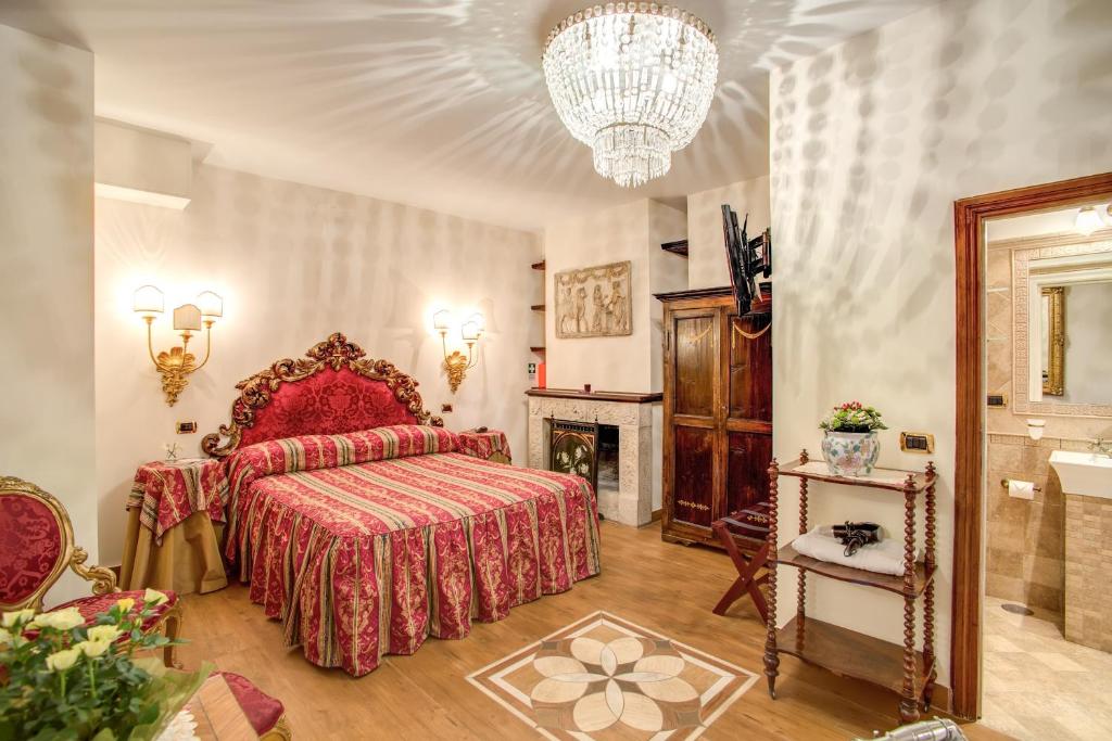 a bedroom with a red bed and a fireplace at Navona Gallery Suites in Rome