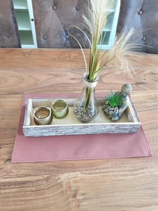 a tray with a vase and some plants on a table at Ferienwohnung Leonie in Goslar