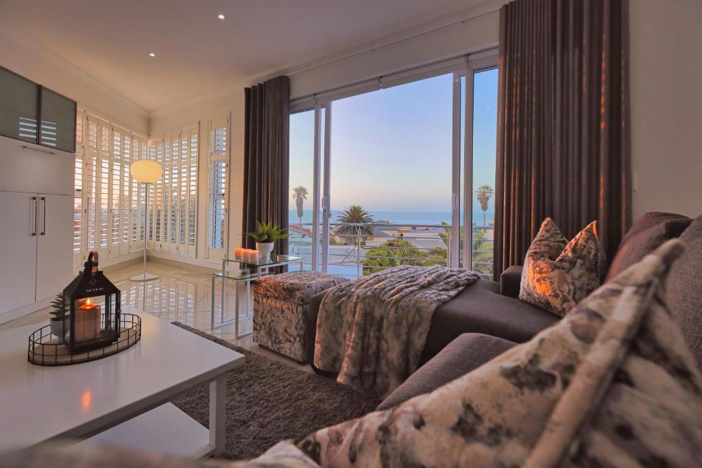 a living room with a couch and a view of the ocean at Denhill Villa Unit 4 in Swakopmund