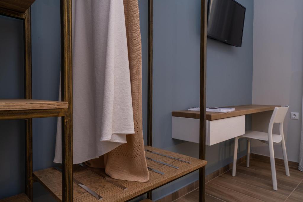 a room with a mirror and a table with a chair at Vagabond Guesthouse in Athens