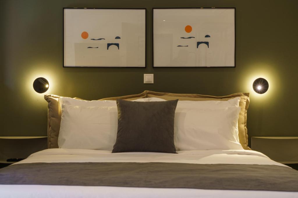 a bedroom with a bed with two faces on the wall at Vagabond Guesthouse in Athens