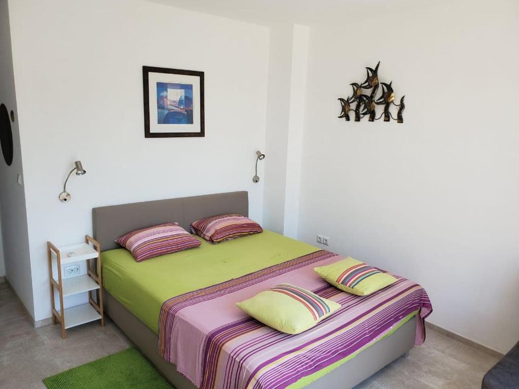 a bedroom with a bed with two pillows on it at Obzor Tatyana Apartaments Natura in Obzor