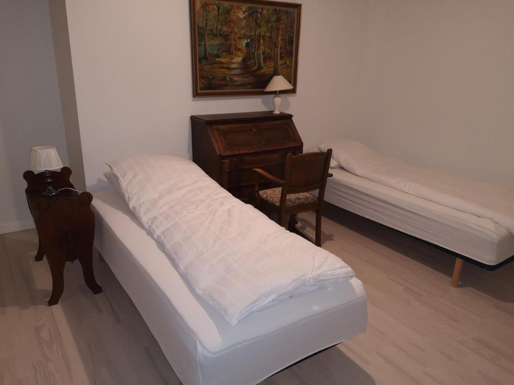 a bedroom with a bed and a desk and a chair at Bøgehus in Vejle