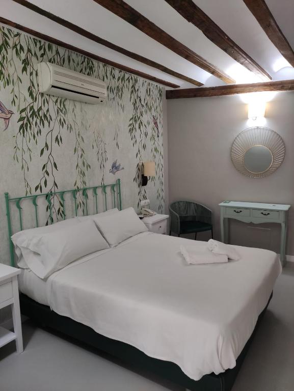 Postel nebo postele na pokoji v ubytování Hotel Almunia