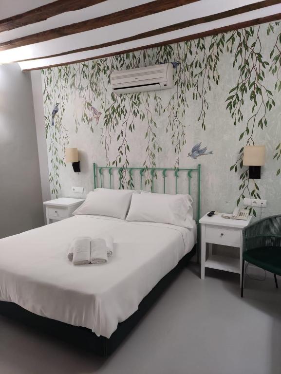 Postel nebo postele na pokoji v ubytování Hotel Almunia