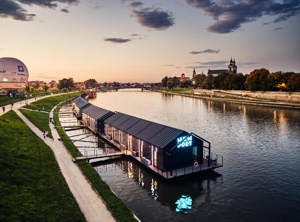 a house on a dock in the middle of a river at New Port - Hotel na Wiśle in Kraków