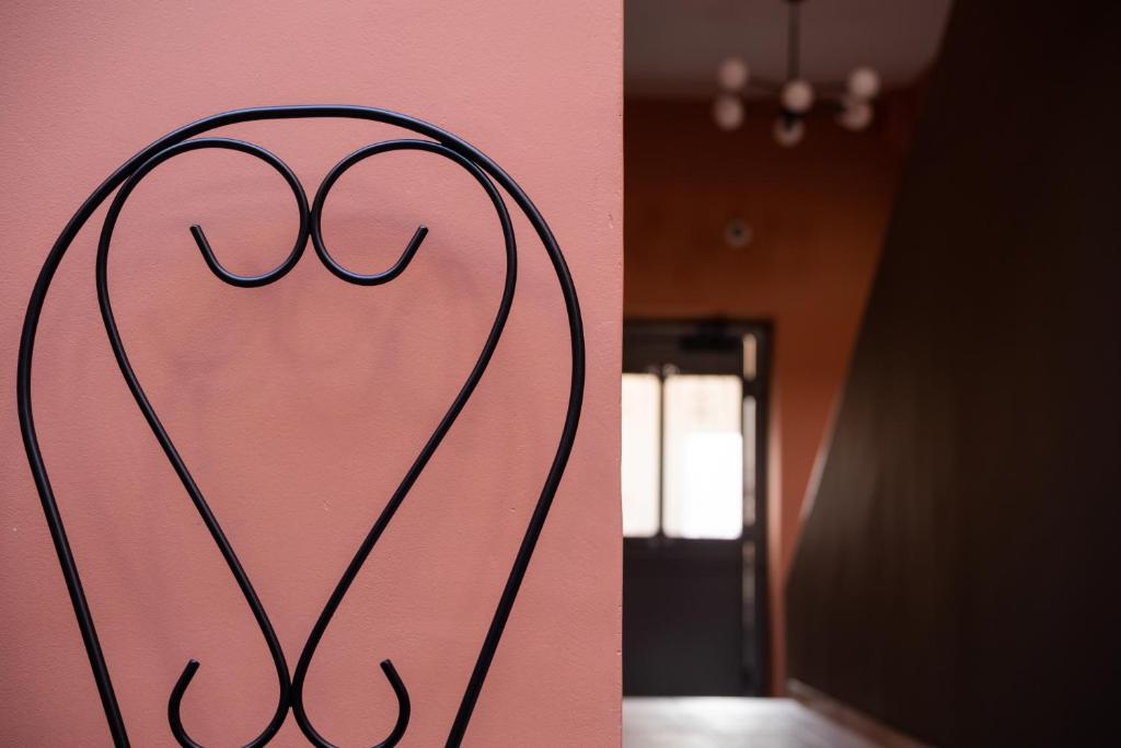 two pictures of a room with a door at Vagabond Guesthouse in Athens