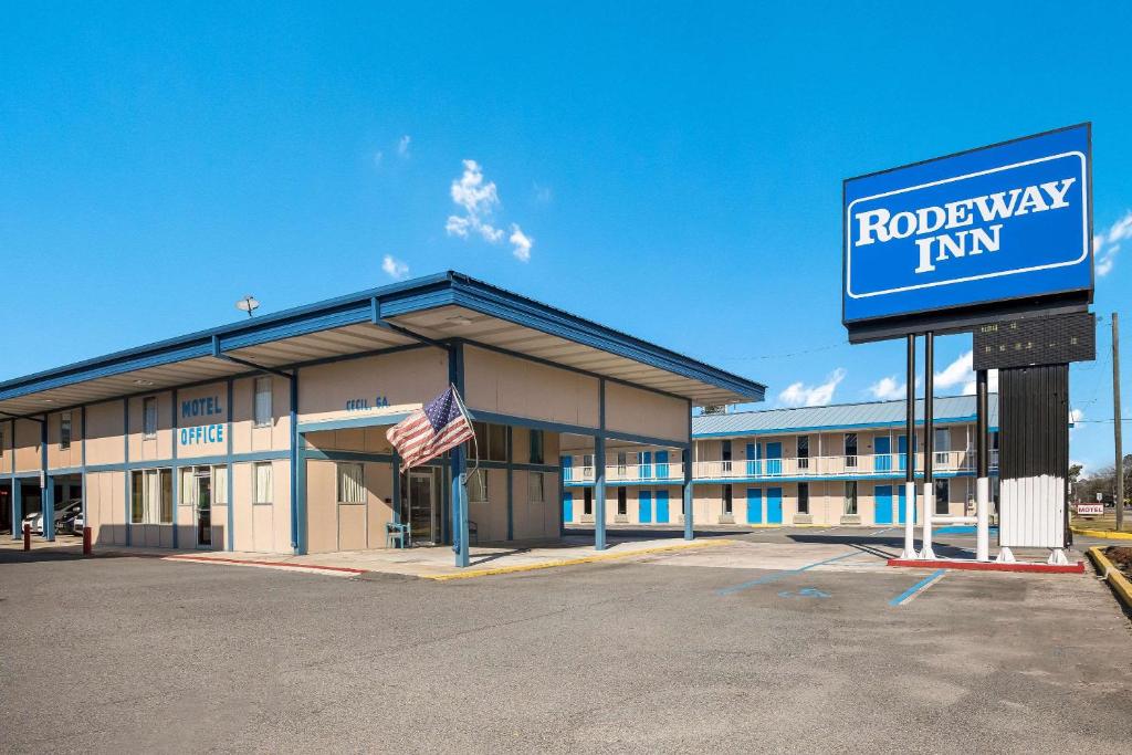 a hotel with a sign in front of a building at Rodeway Inn 