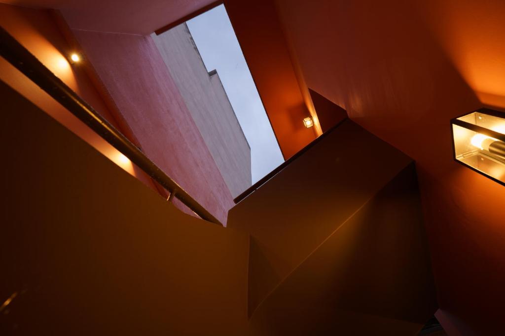 a dark room with stairs and a window at Vagabond Guesthouse in Athens