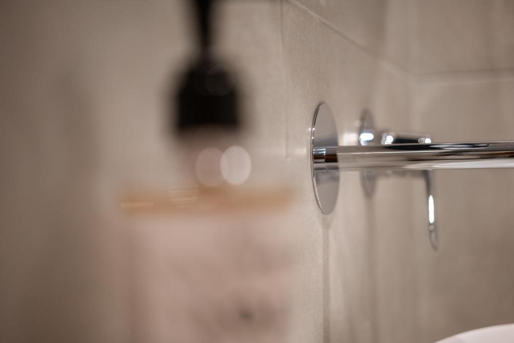 a glass shower door in a bathroom at Vagabond Guesthouse in Athens