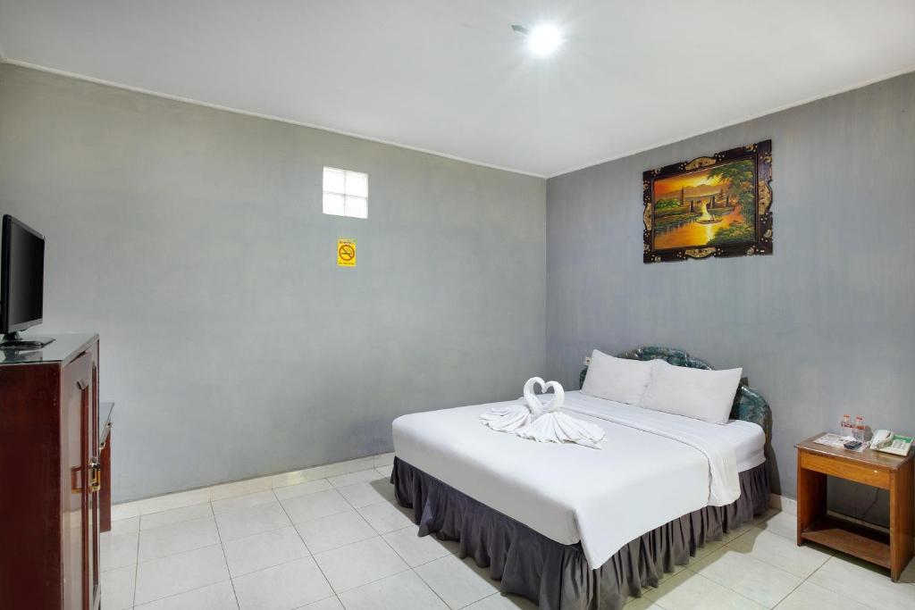 Postel nebo postele na pokoji v ubytování Negara Hotel - CHSE Certified