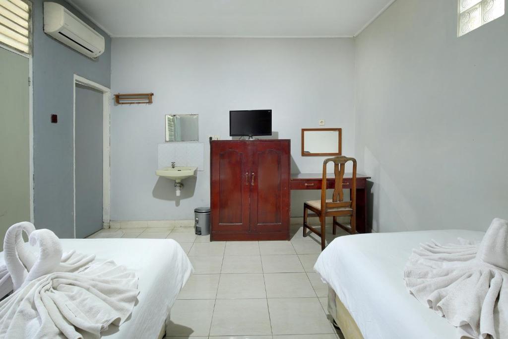 Postel nebo postele na pokoji v ubytování Negara Hotel - CHSE Certified