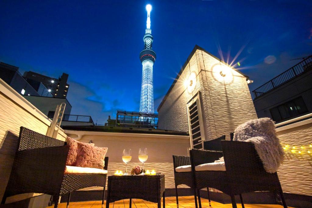 a rooftop patio with a view of the eiffel tower at Skytree view Oshiage in Tokyo