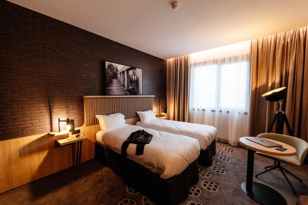 Säng eller sängar i ett rum på ibis Styles Arras Centre