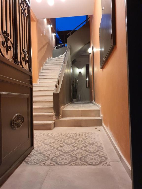 a hallway with stairs and a brown door and a staircase at Vagabond Guesthouse in Athens