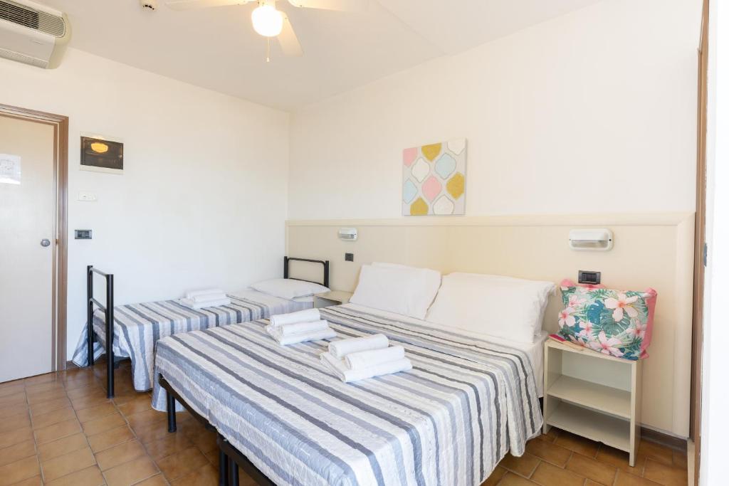 Postel nebo postele na pokoji v ubytování Hotel Mignon Riccione Fronte Mare