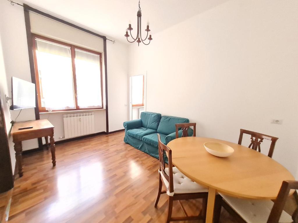 a living room with a blue couch and a table at BRERA - ForoBuonaparte Cozy apartment in Milan