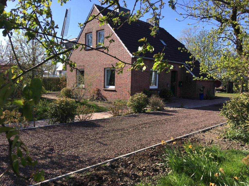 a house with a gravel driveway in front of it at Haus 5 Zehn in Werdum