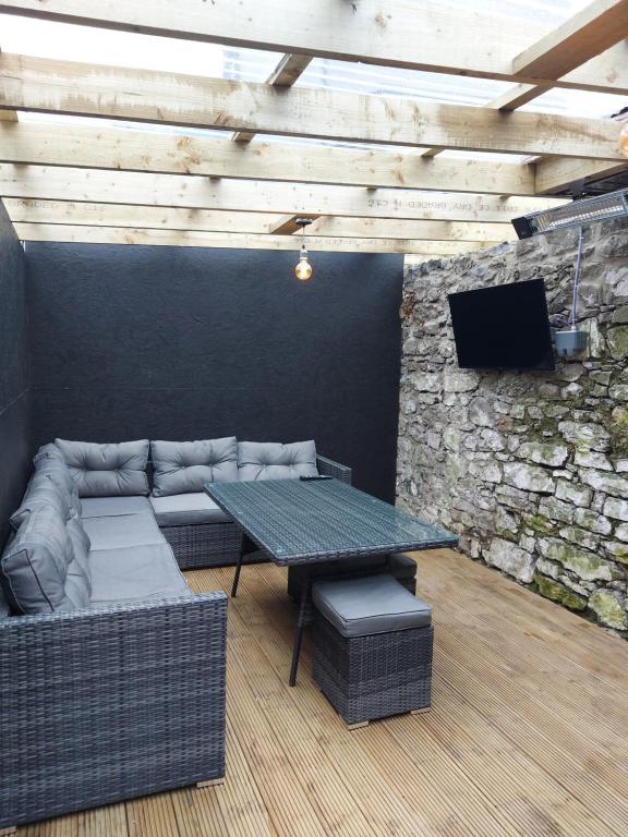 a living room with a couch and a table and a tv at 4 Eyre Square Lane in Galway
