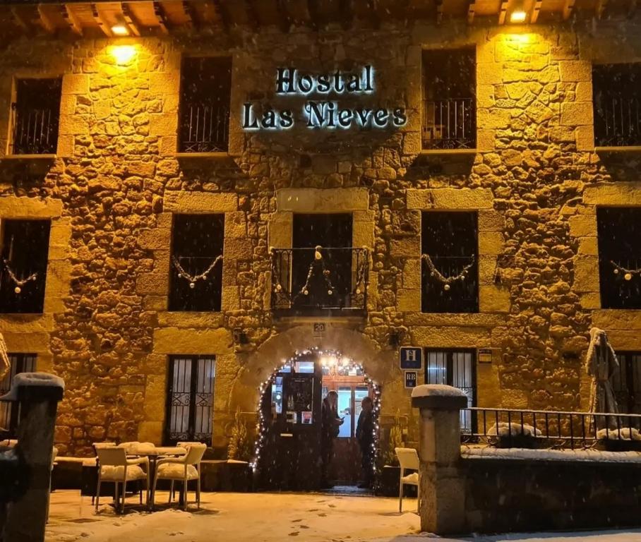 a building with a sign that reads hospital las wolves at Hostal Las Nieves in Salduero