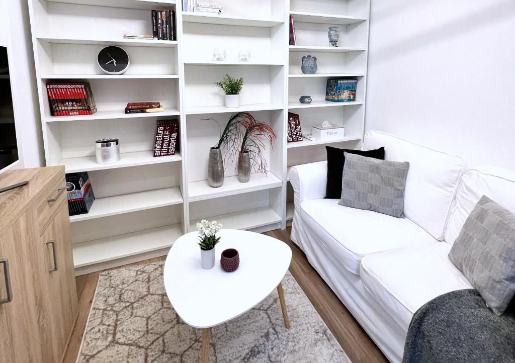 a living room with a white couch and a table at Hot Spot - Premium Loft - Sanador Victoriei in Bucharest