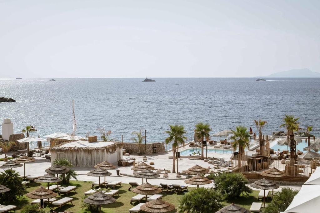 a view of a resort with a pool and the ocean at Maya Beach Resort in Massa Lubrense