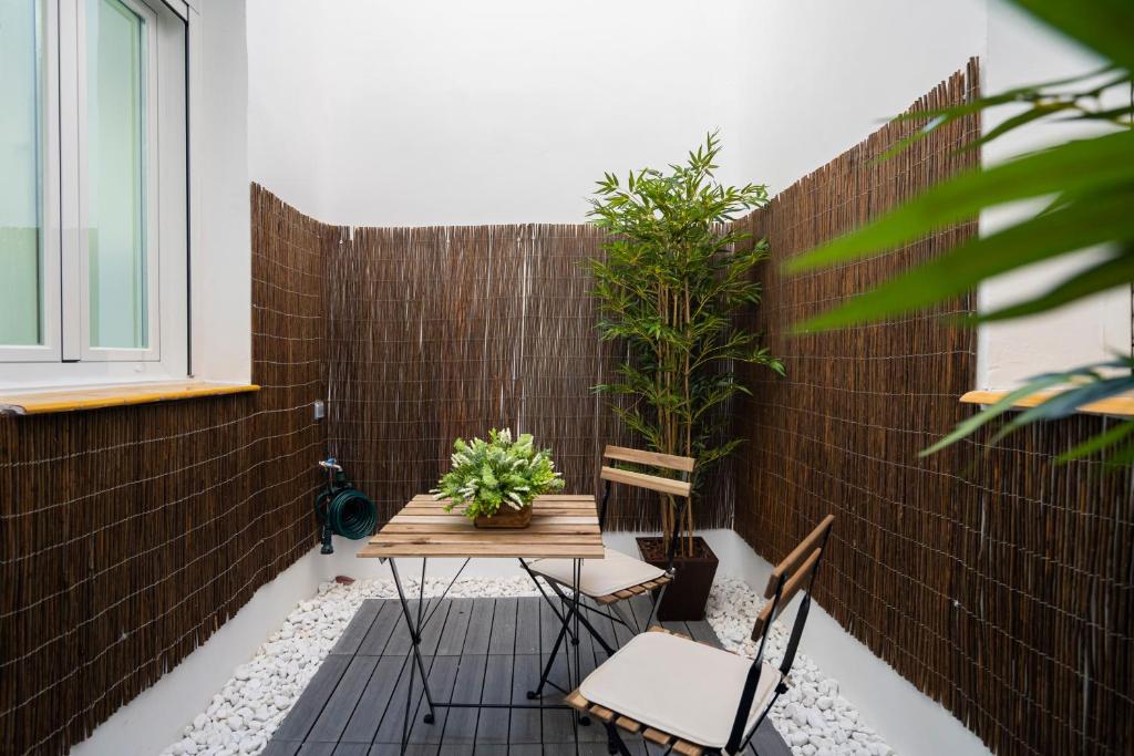 a patio with a table and chairs and a brick wall at Moncloa Apartment in Madrid