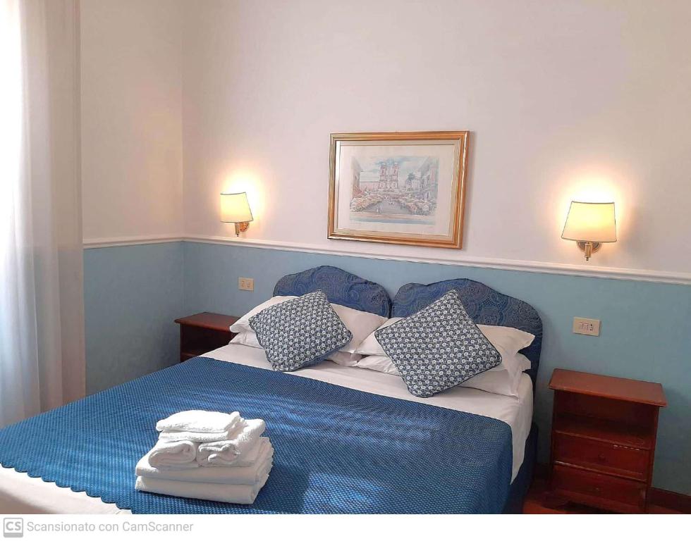 Postel nebo postele na pokoji v ubytování Hotel Porta Pia