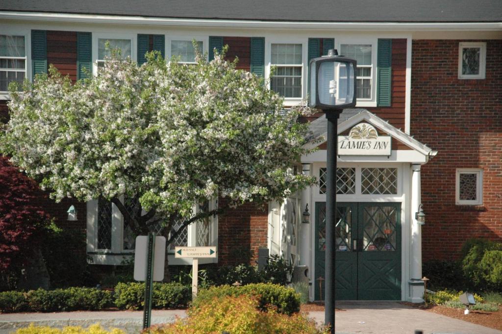 a street sign in front of a house with a tree at Lamies Inn & The Old Salt Tavern in Hampton
