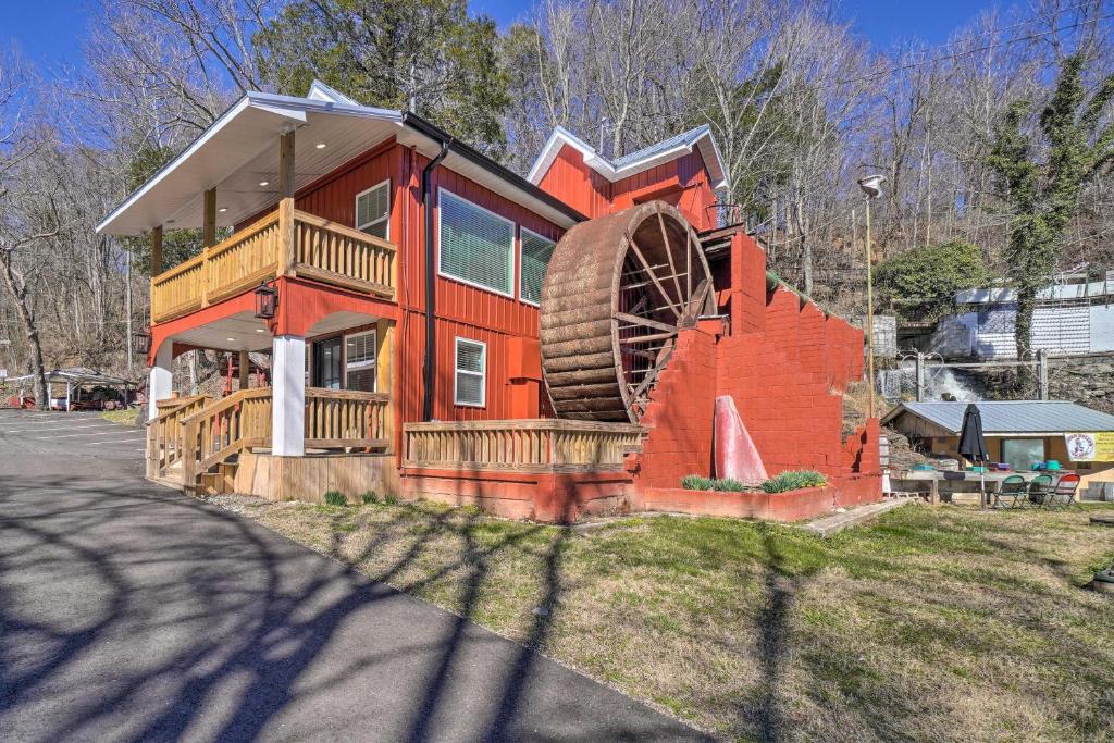 a large house with a large wheel on the side of it at Peaceful Cookeville Cabin on 52 Acres! in Cookeville
